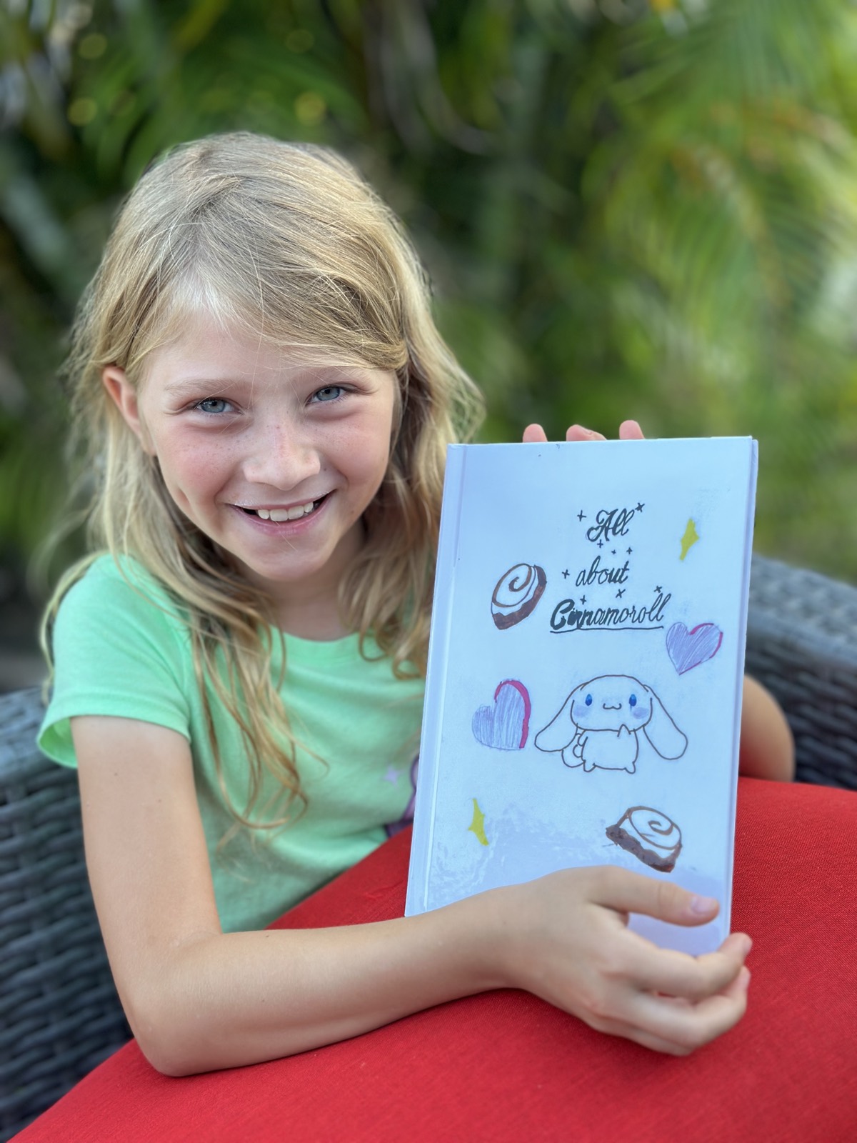 Child proudly holding a printed StoryCrafters hardcover book