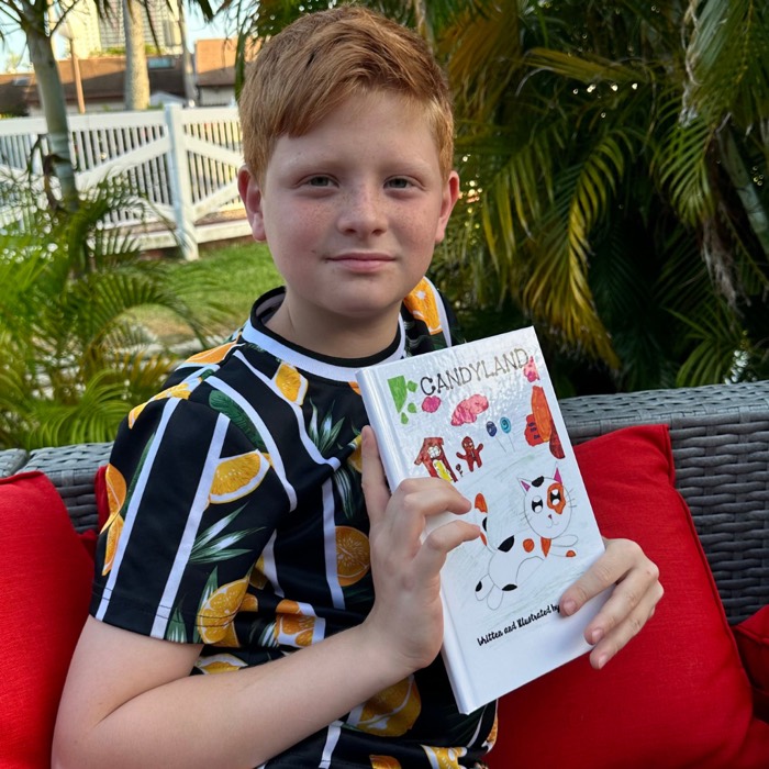 Child holding their printed hardcover book