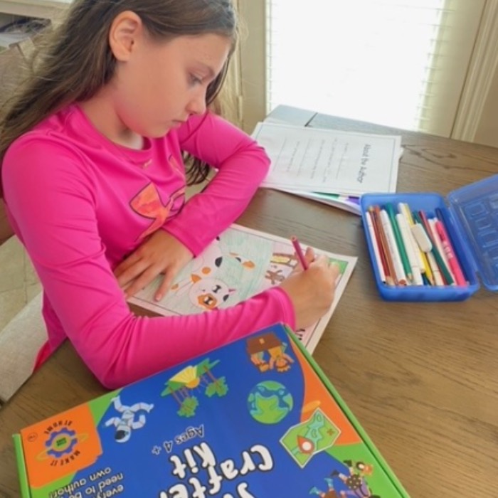 Child working on their story at a table